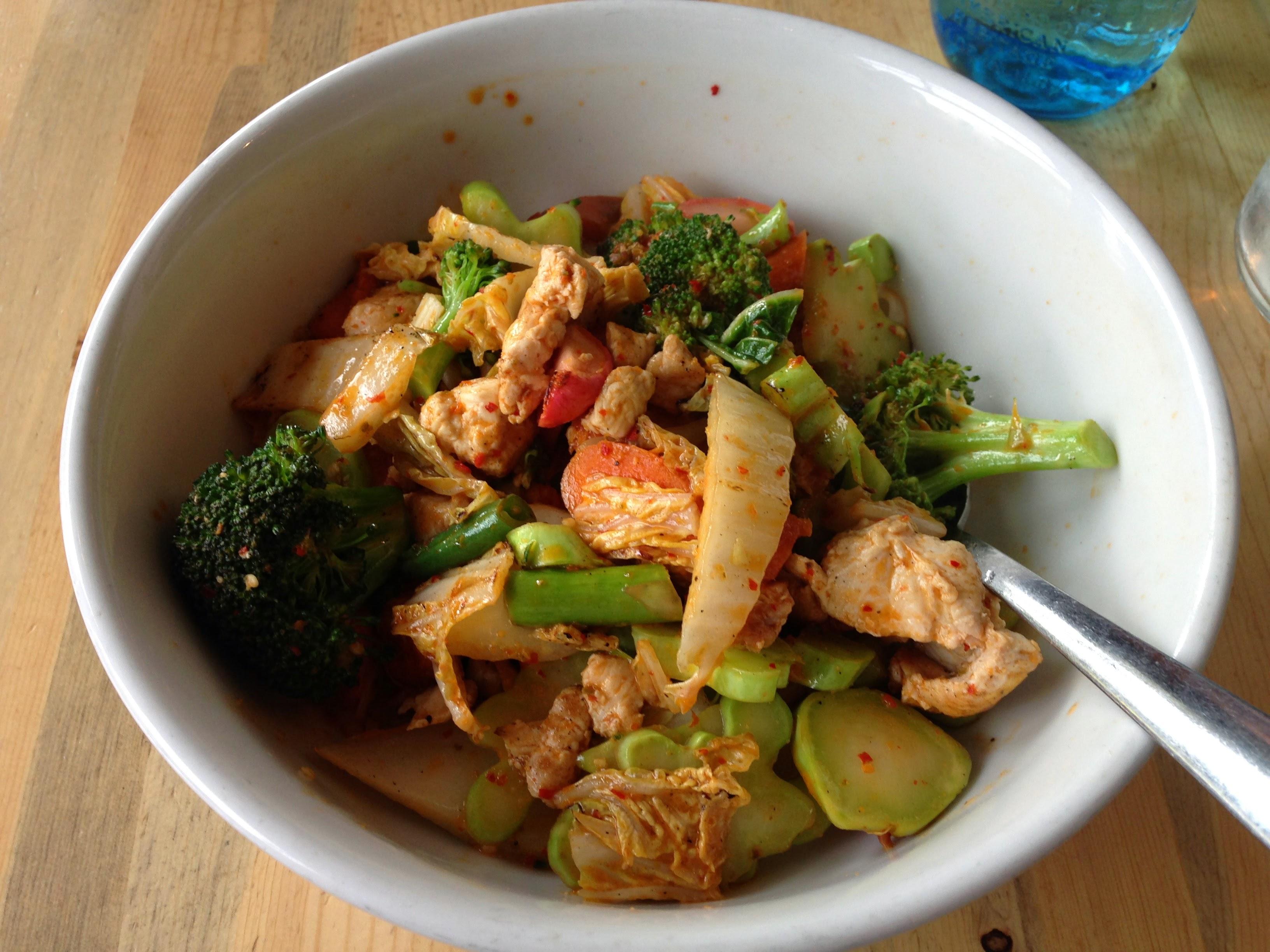 A bowl of chicken and vegetables.