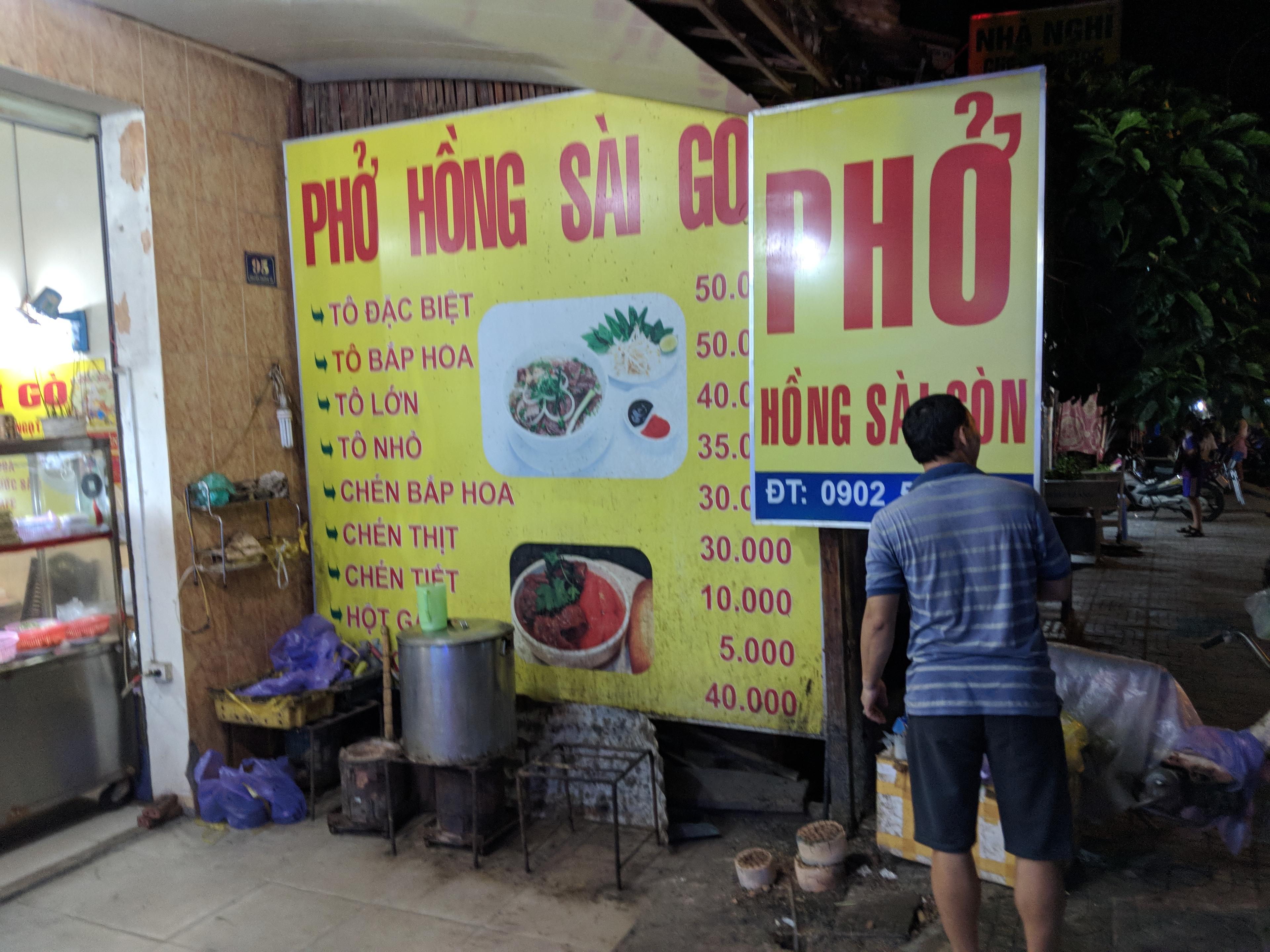 A bright yellow sign at a Vietnamese restaurant.