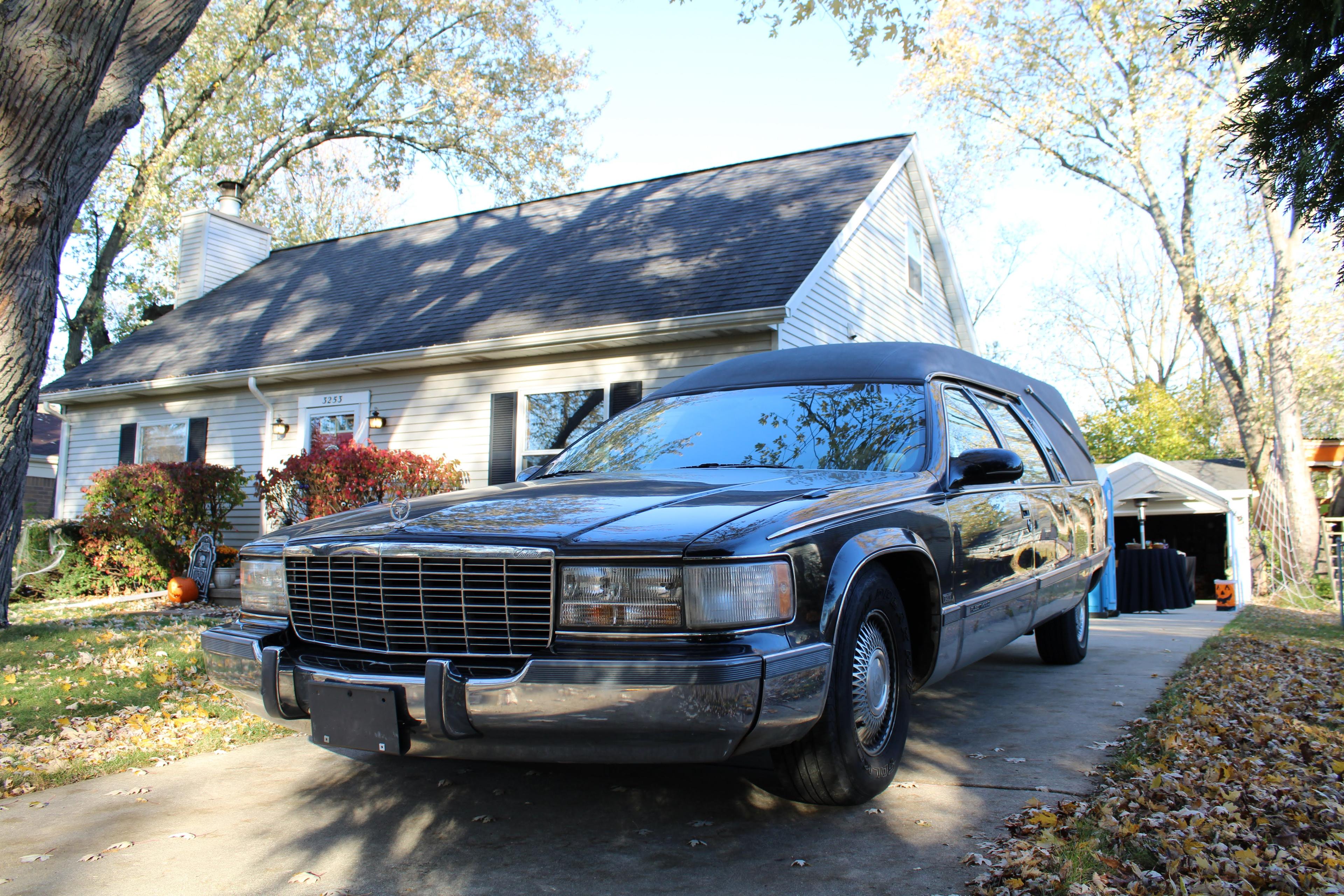A Cadillac parked in front of a house.