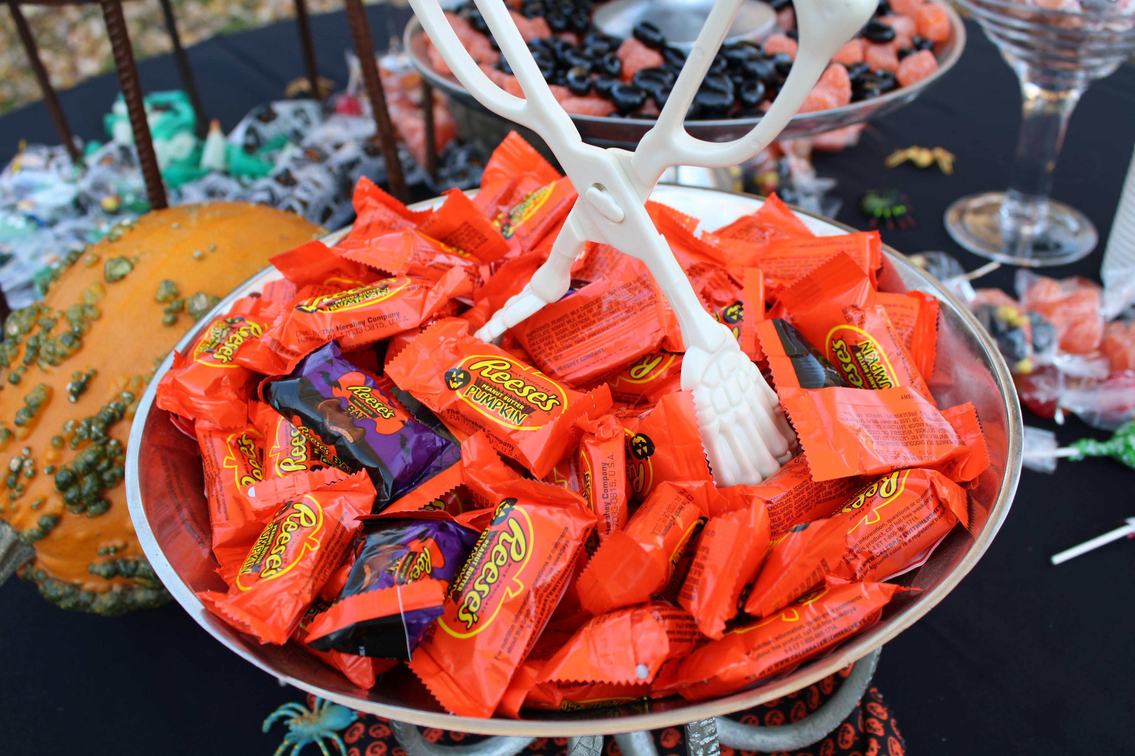 A bowl full of orange Reese's candy.