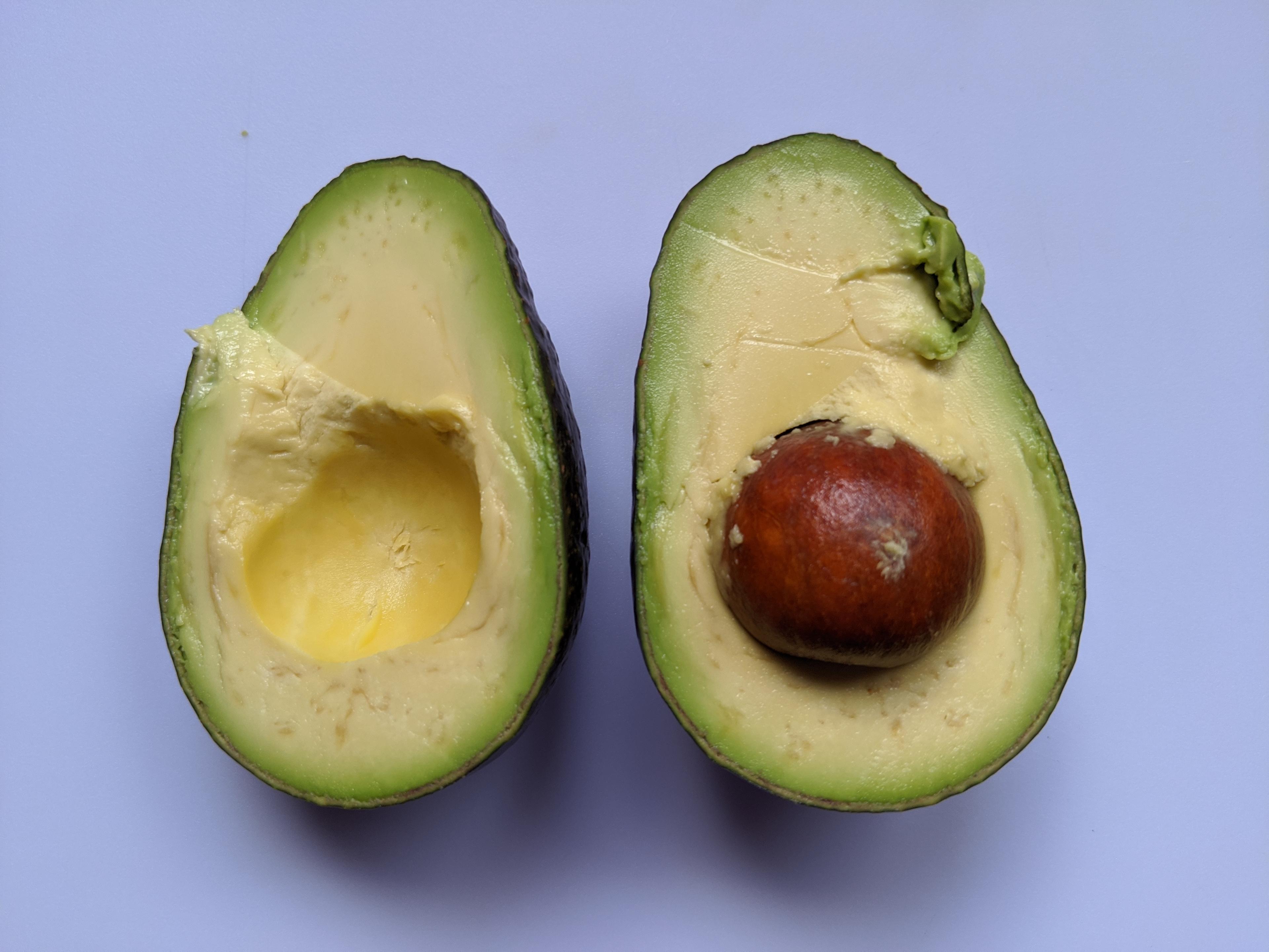 Two halves of an avocado.