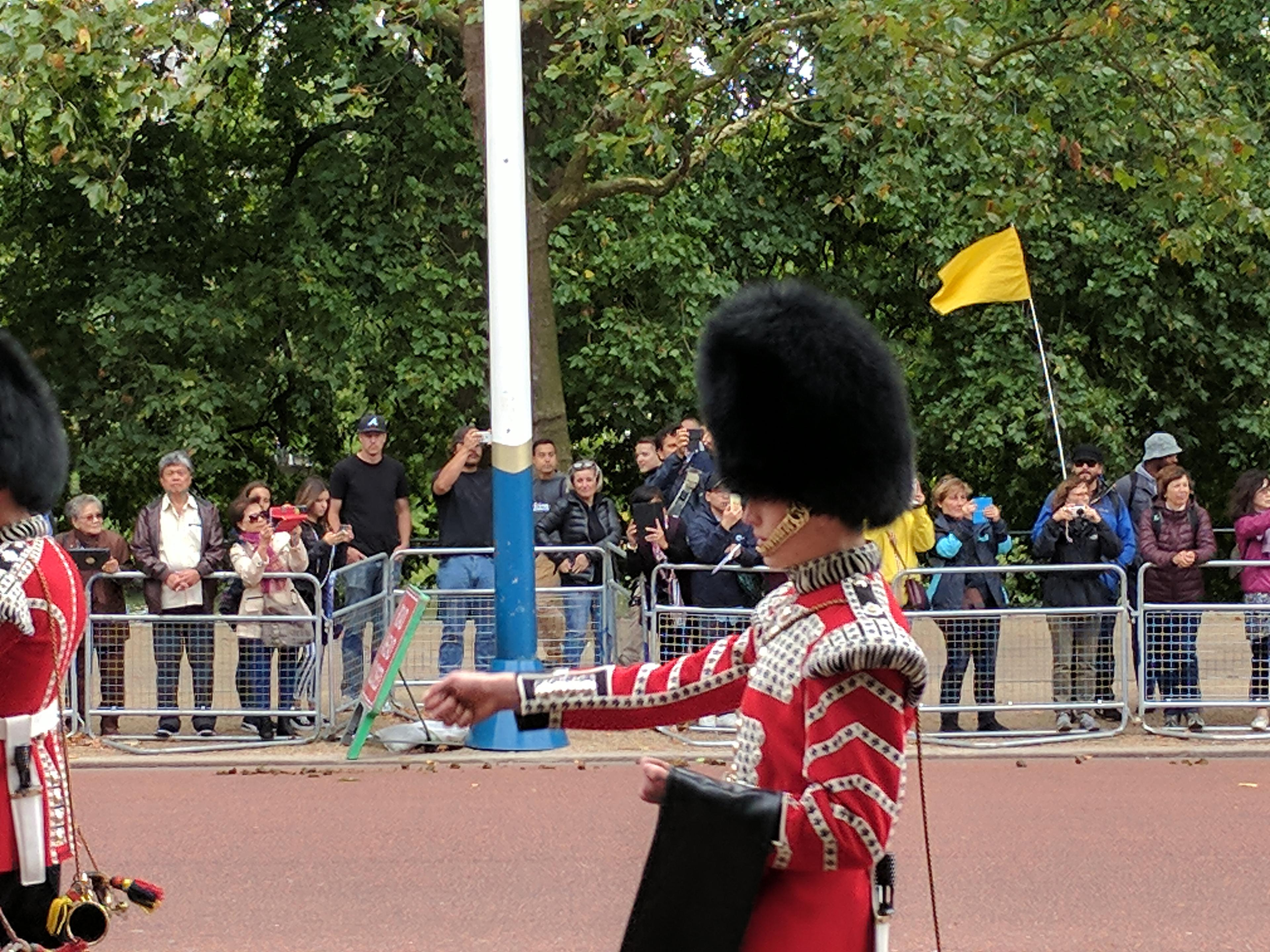 A British military procession with onlookers.